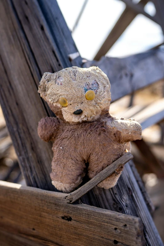 a teddy bear sitting on a wooden porch