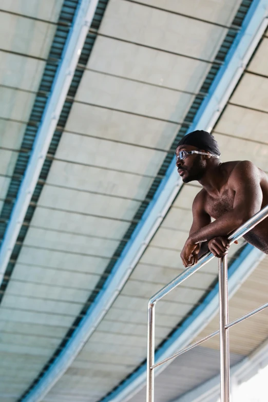 a man with  on standing by a railing