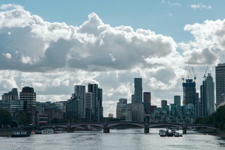 a very large city with buildings along side a river