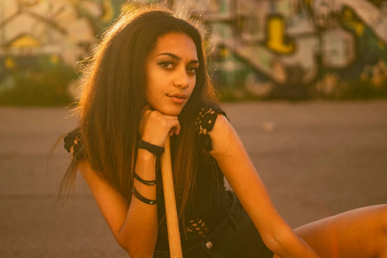 a pretty young lady wearing an ornate black top and black shorts