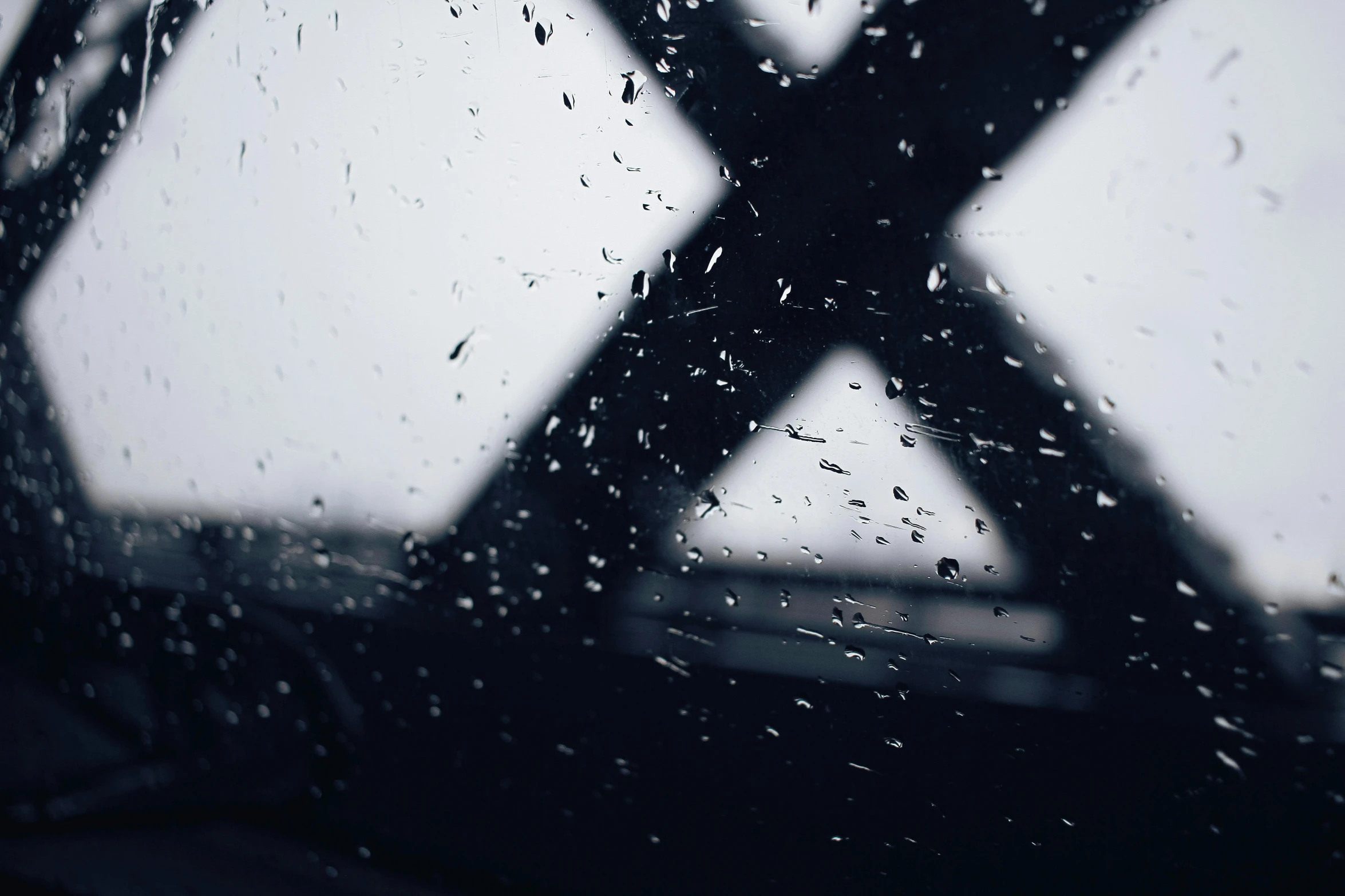 a large building through rain covered window glass