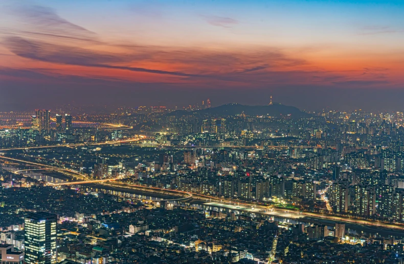 view of a city with some buildings at sunset