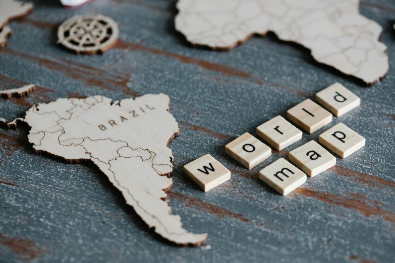 small wood letters that spell out a word world map