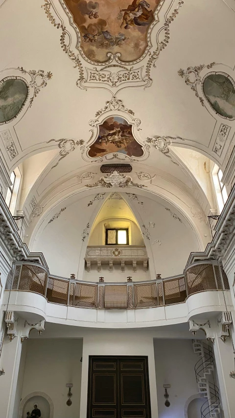 a church with multiple painted ceilings and a doorway