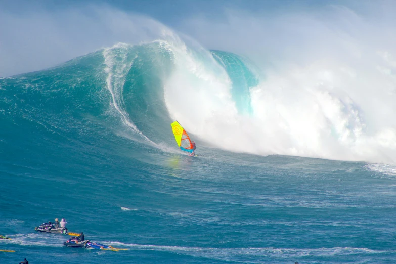 a man is surfing in the ocean while another man watches