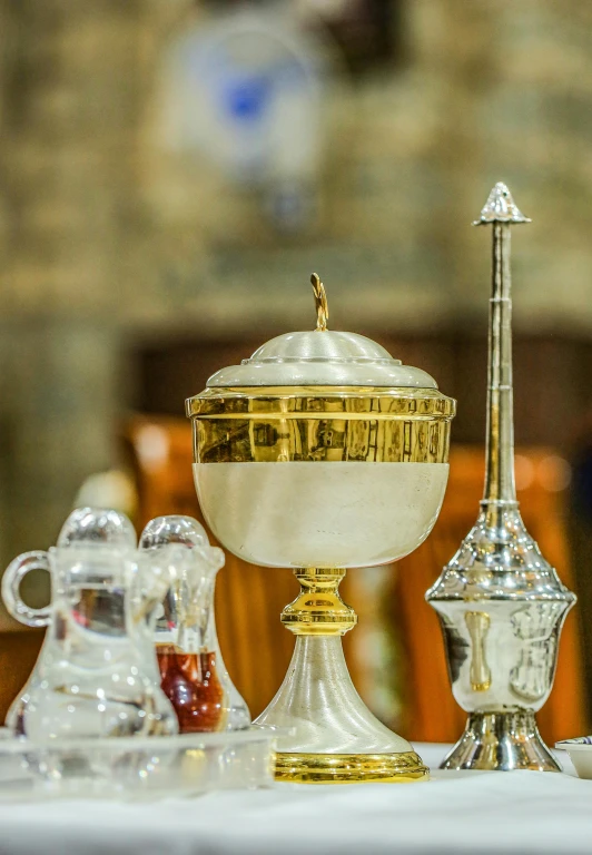 a table with silver and golden items on top