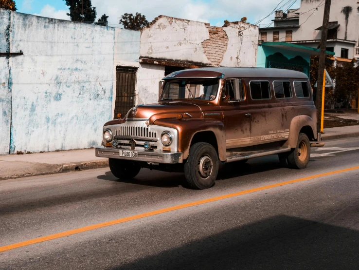 a brown and white truck parked on a street