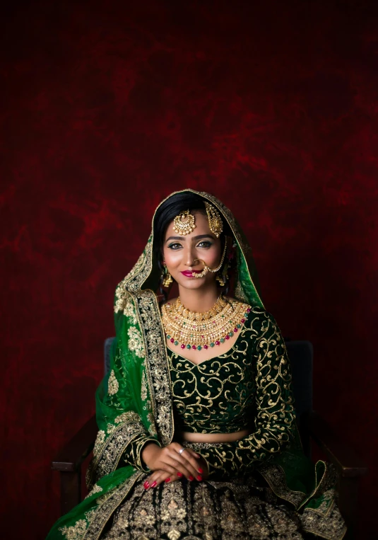 woman with ethnic costume and jewels on red background