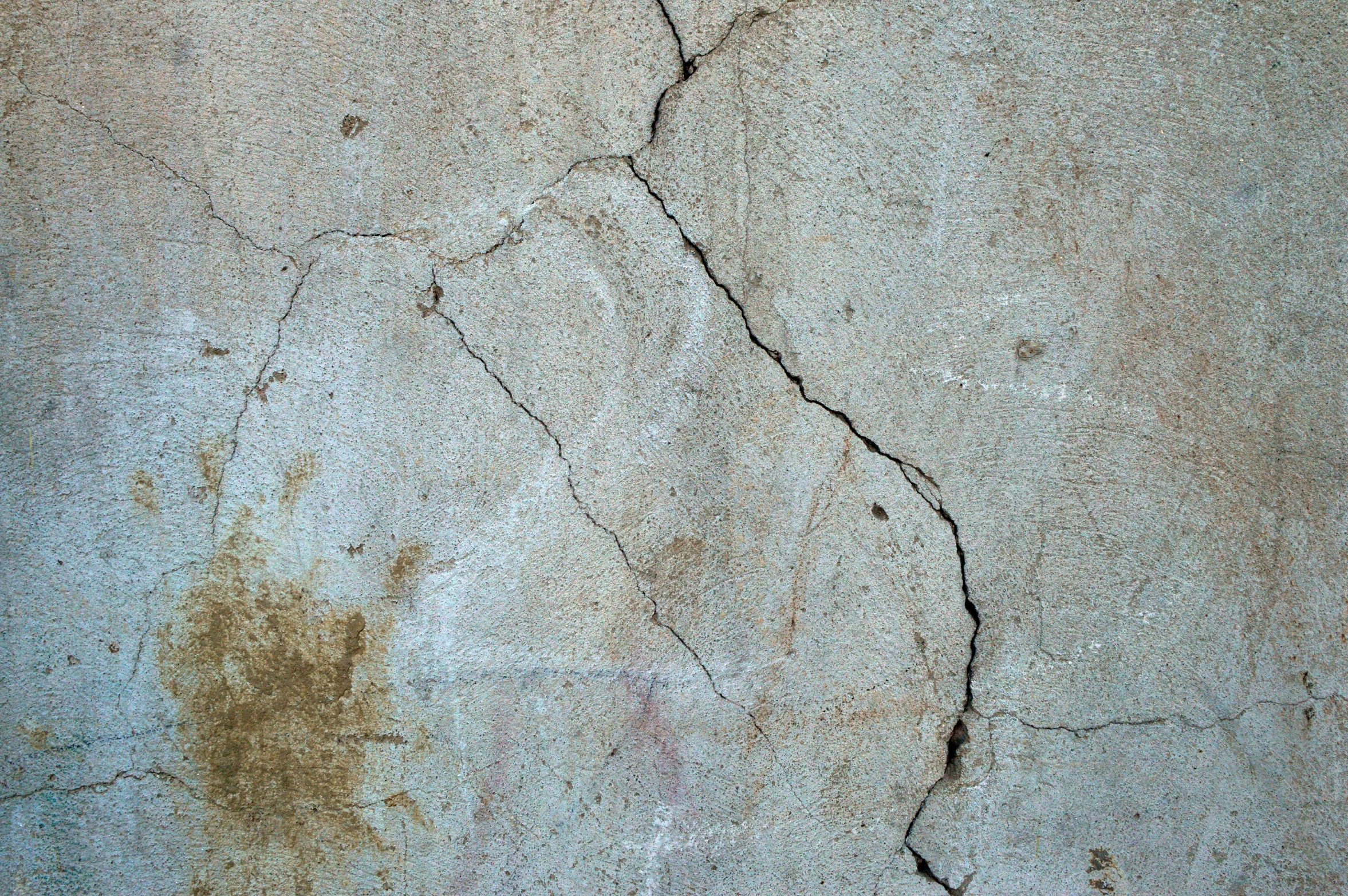 a ed up concrete wall that is peeling