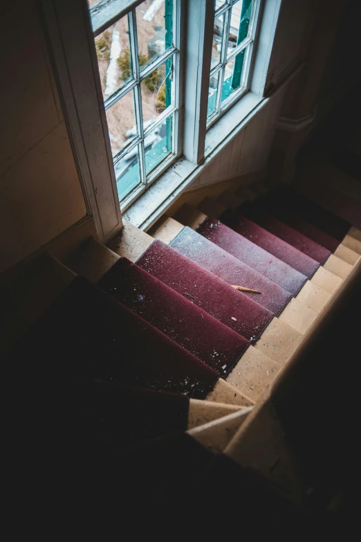 an open window above an empty staircase next to a doorway