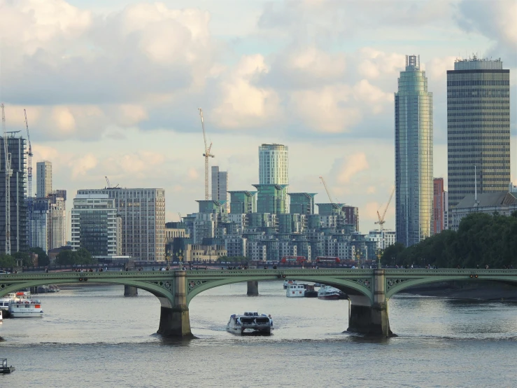 a city skyline and bridge crossing a large body of water