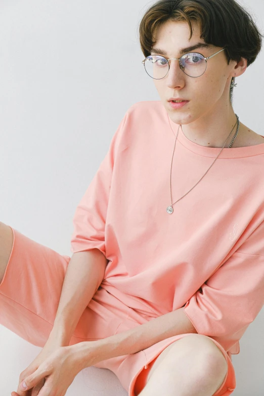 a girl wearing glasses, sitting on the floor