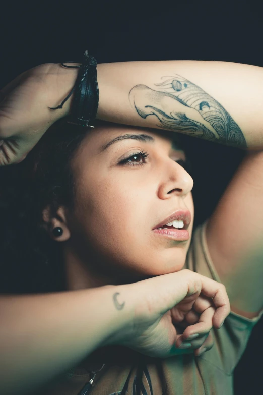 a woman with tattoos on her arm and arms