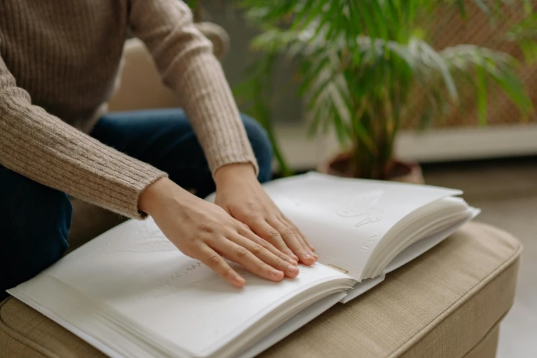 woman sitting on a bench and holding a book open