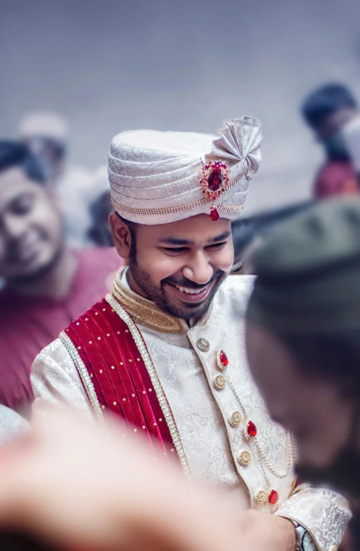 a smiling man in traditional attire is pographed