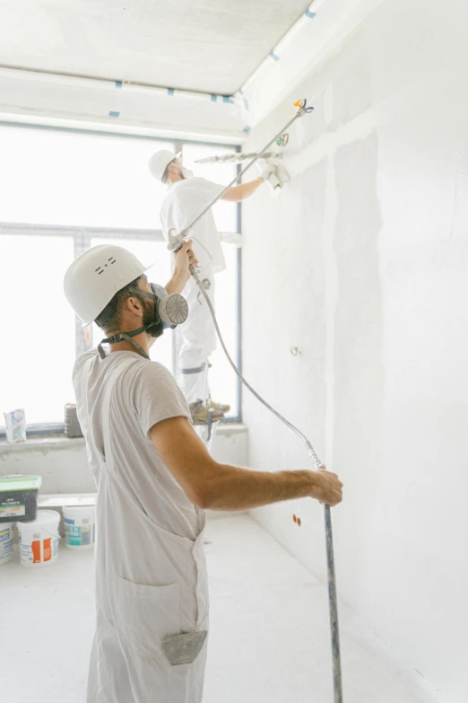 a man is painting the walls of his house