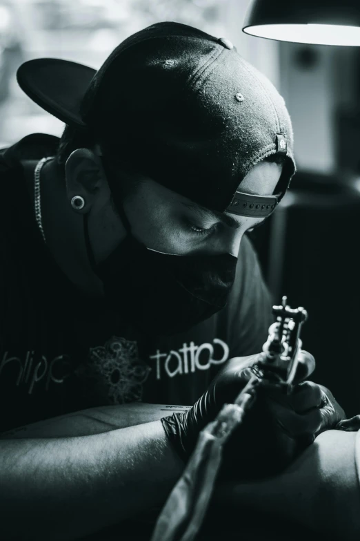 man in black shirt and glasses writing on the table