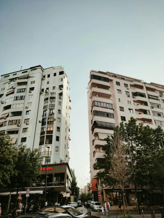 an intersection with cars in the foreground and tall buildings in the background