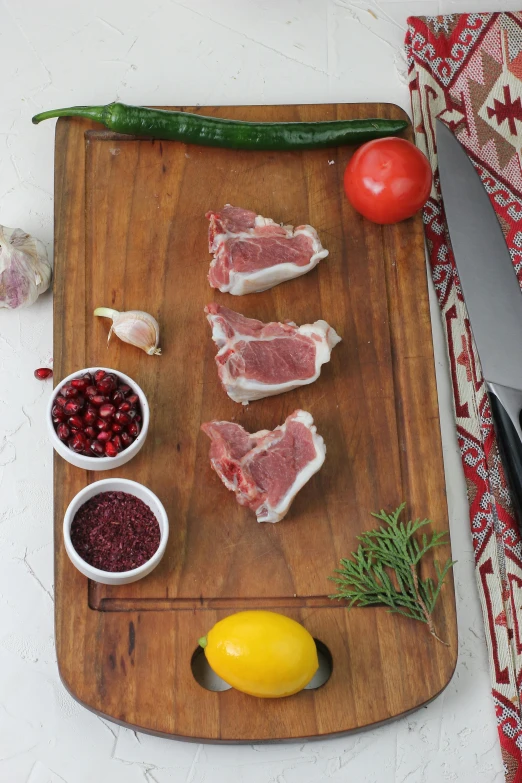 a wooden  board with a cut up meat and condiments on it