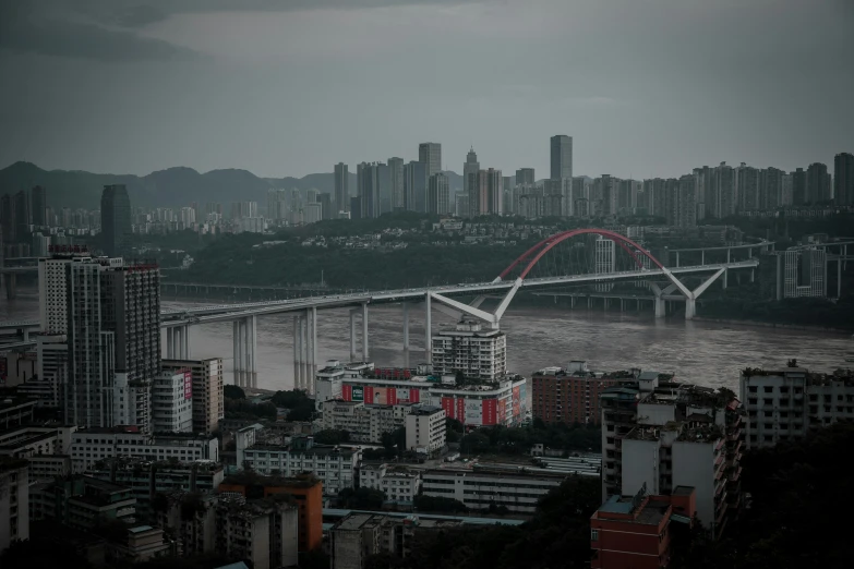 a large bridge that crosses over the water near buildings