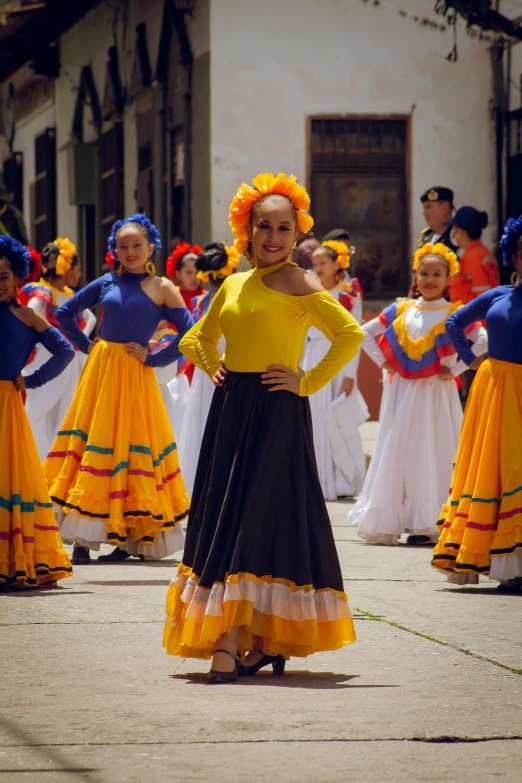 women in brightly colored clothes standing on the sidewalk