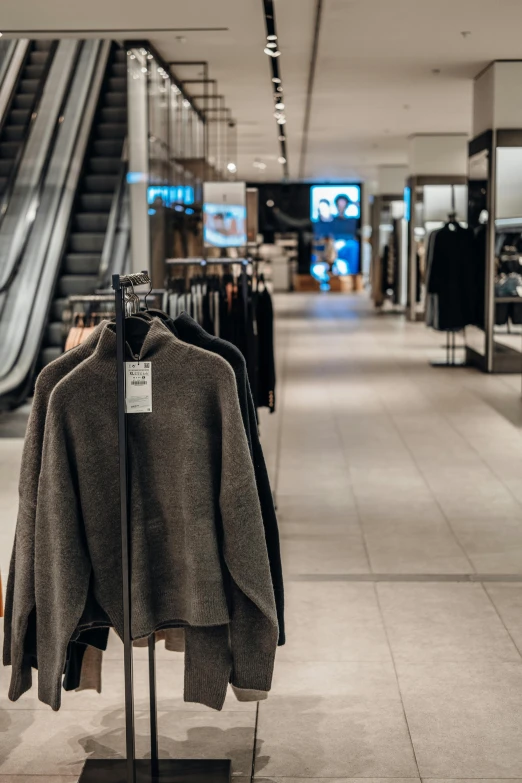 an indoor view of some clothes hanging on a rack