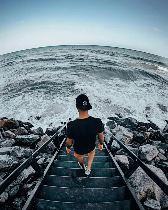 a person climbing a stairs to the water