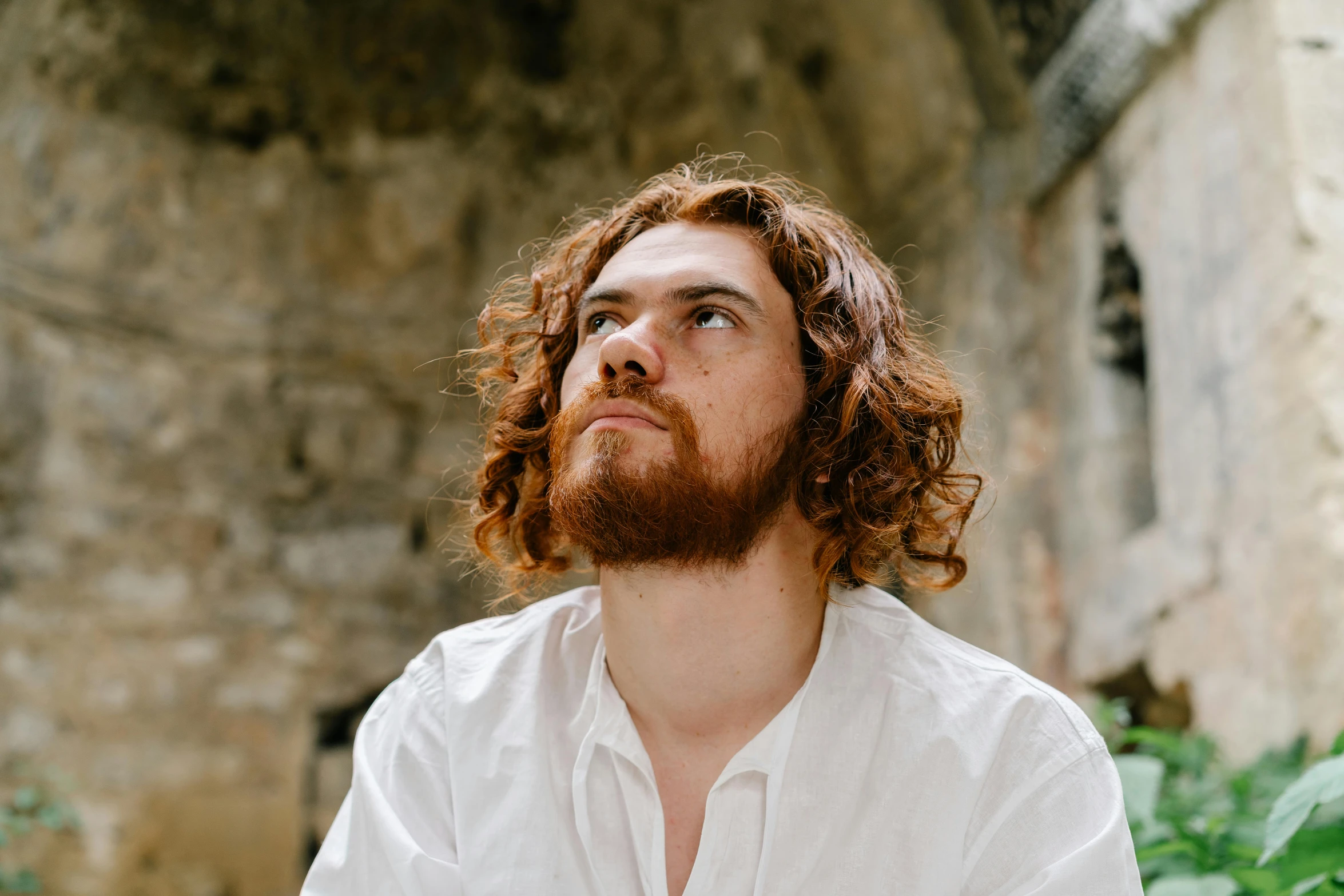 a man that is standing with his head turned