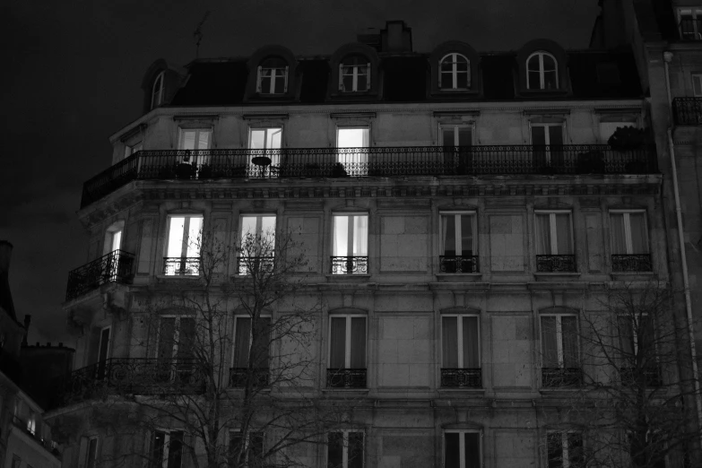 an outside view of a house on the street at night