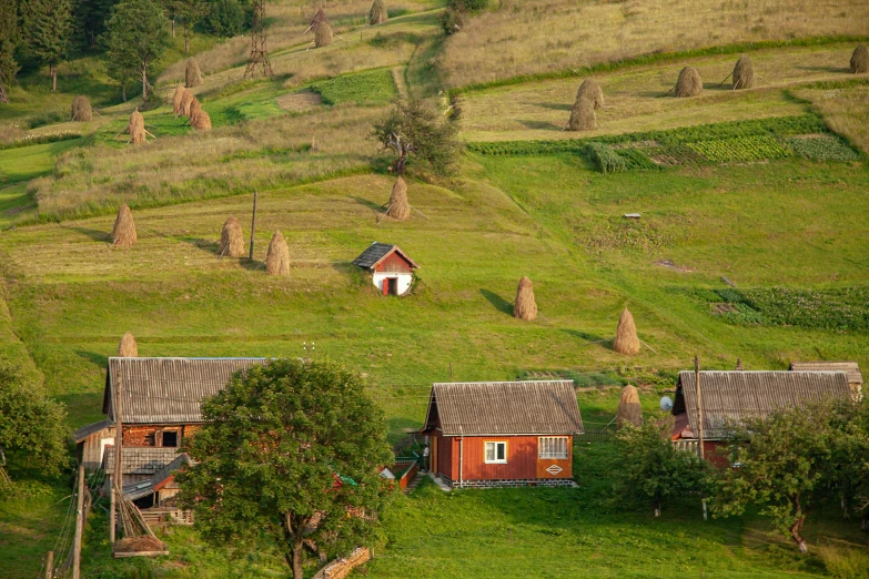 a small cabin is nestled on the top of a large hill