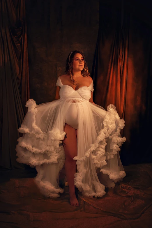 a model in a white dress that is falling on the ground