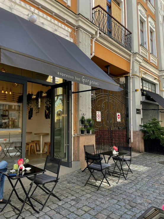 outdoor seating and tables on cobbled walkway in urban area