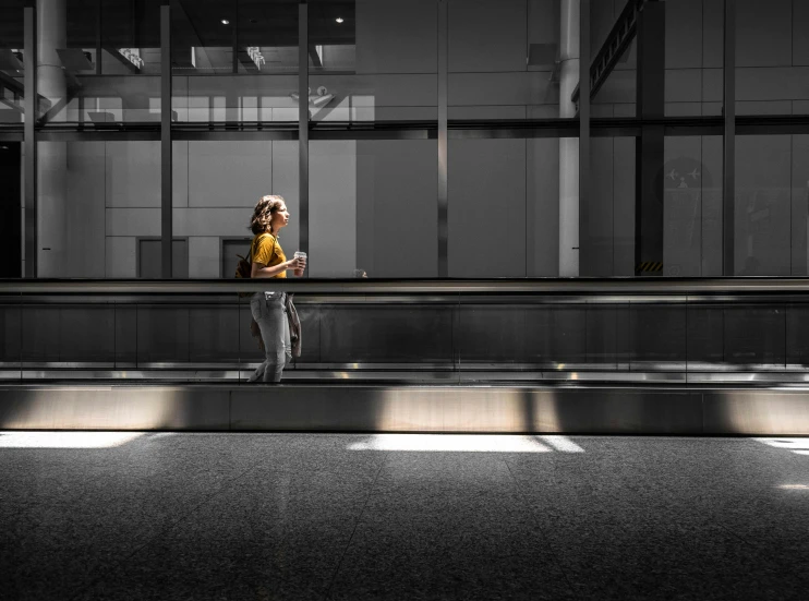 woman with cell phone in city train station