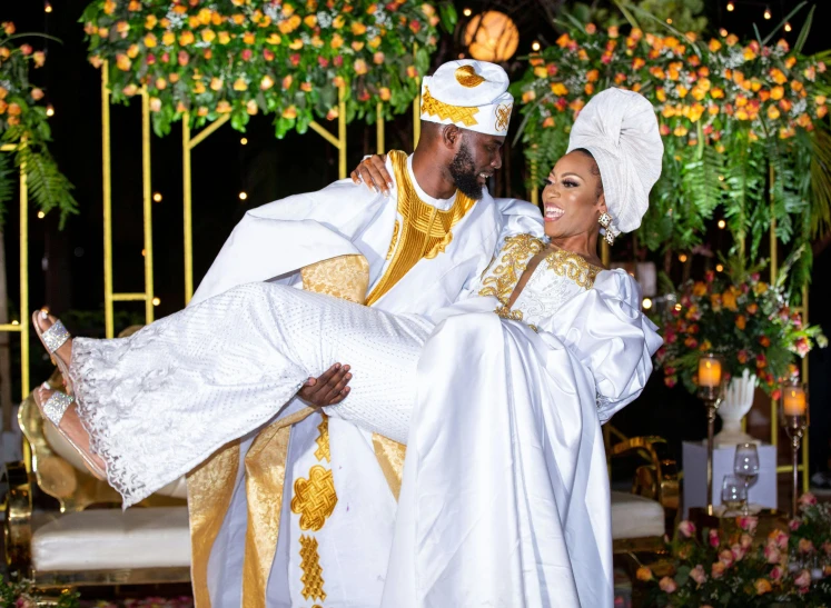 the bride and groom hug while they are dressed up