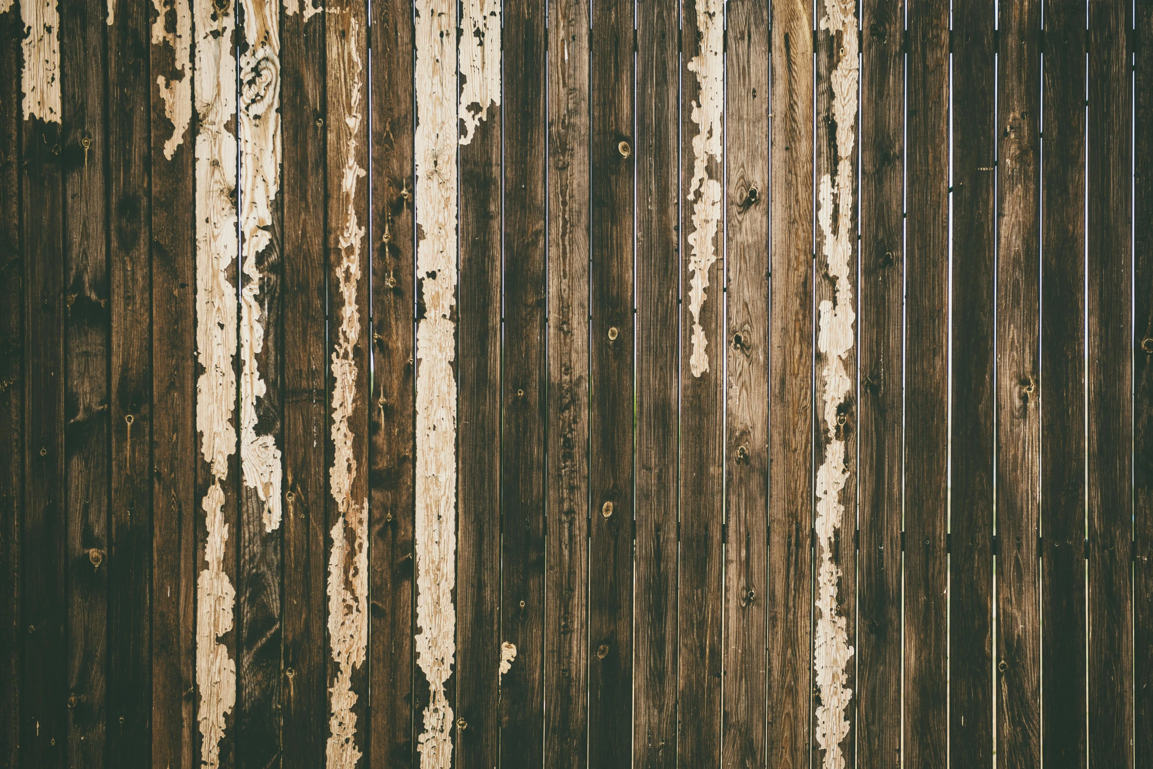 brown wooden wall with a very rusted paint line