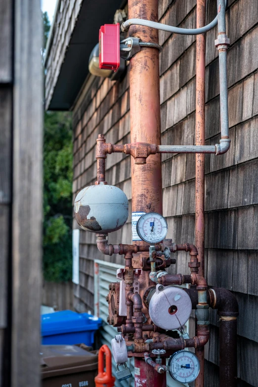 various valves, gauges and valves on a red pole