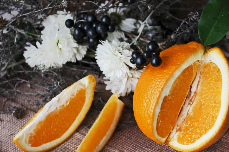 an orange sliced and placed on top of flowers