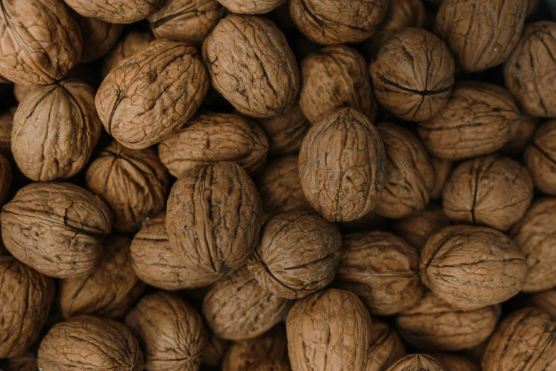 a mixture of walnuts gathered together and in a basket