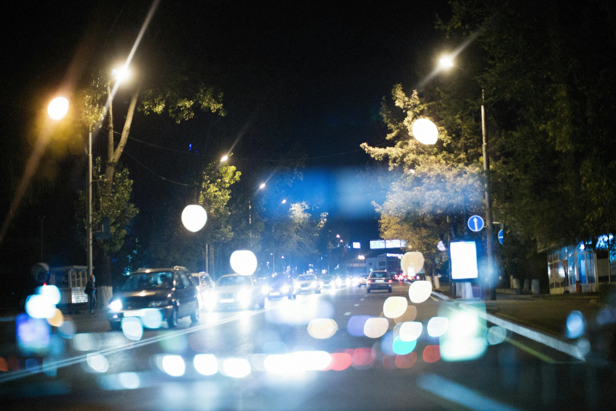 street lights lit up on a busy highway