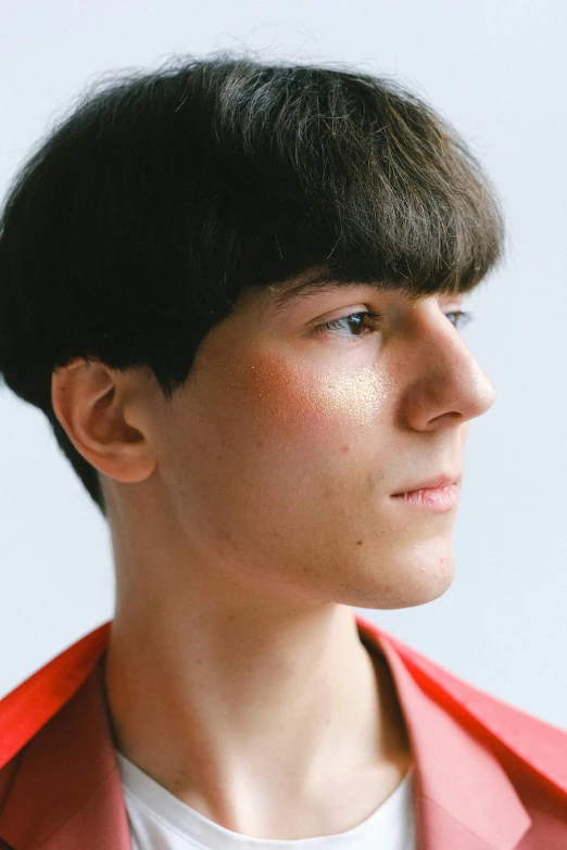 a woman in an orange blazer looking up at soing