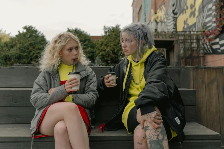 two women in a park sitting on a bench