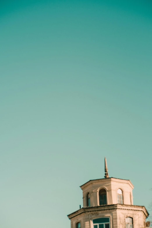 a bird flying in the sky over a building