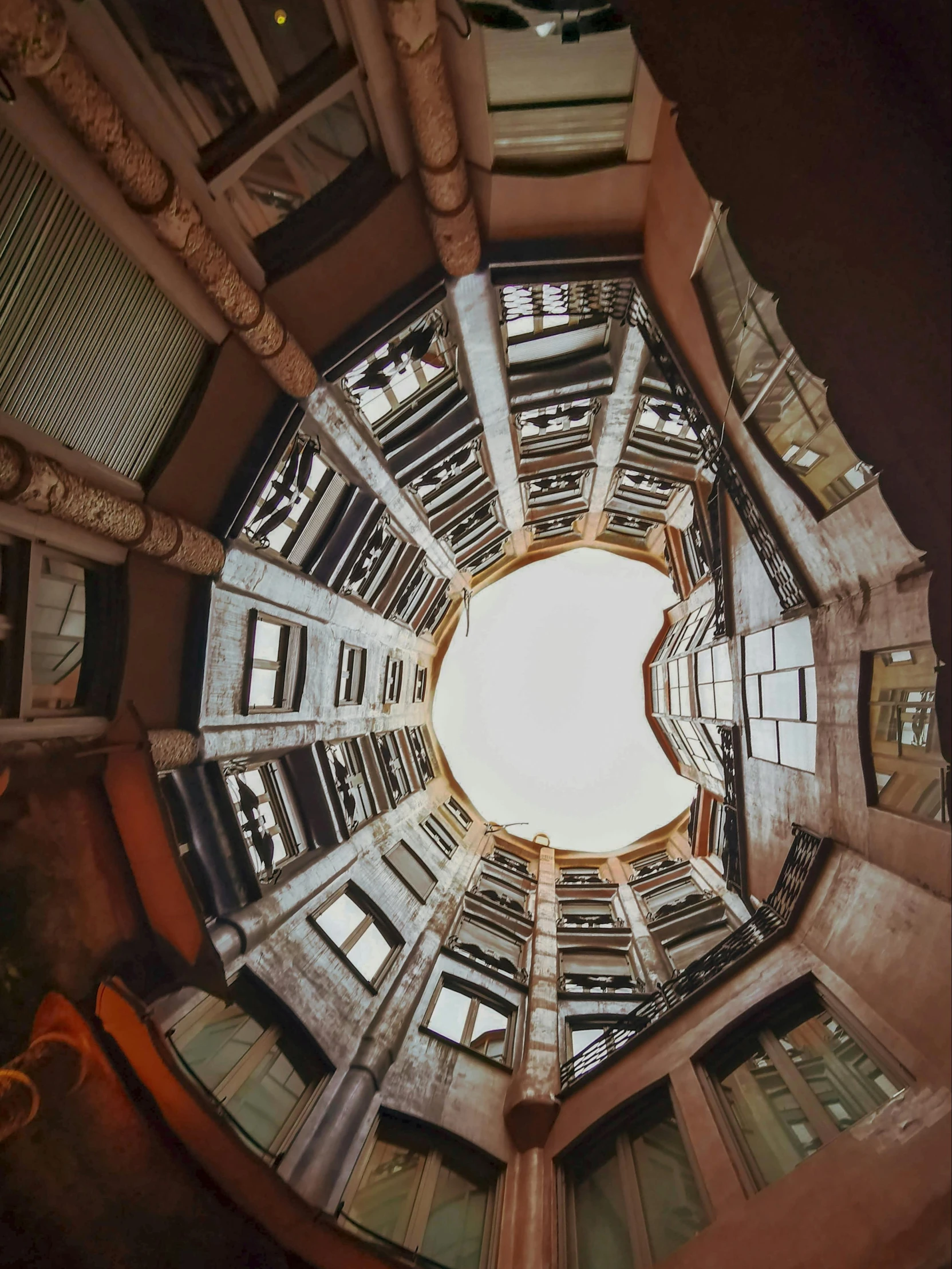 a circular picture looking up at a clock tower