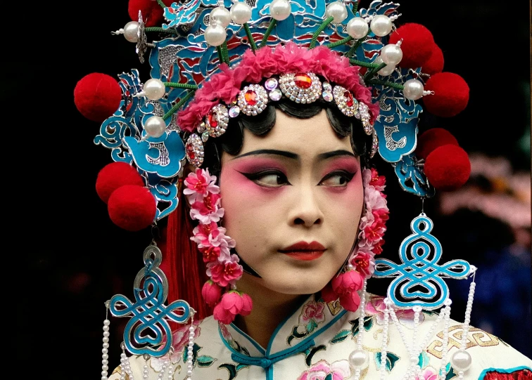 a woman in an asian style fashion with beads and decorations