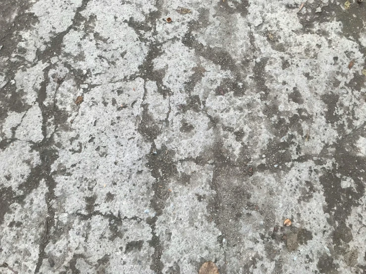 the cement surface is chipped with white paint