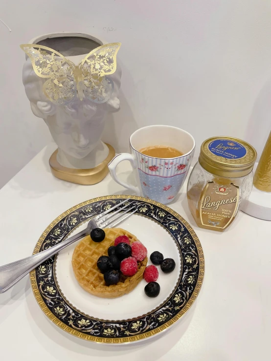 a waffle covered in fresh berries on top of a plate