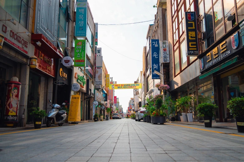 a quiet city street with stores and signs