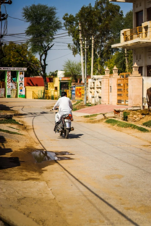 a man riding a motorcycle on the road