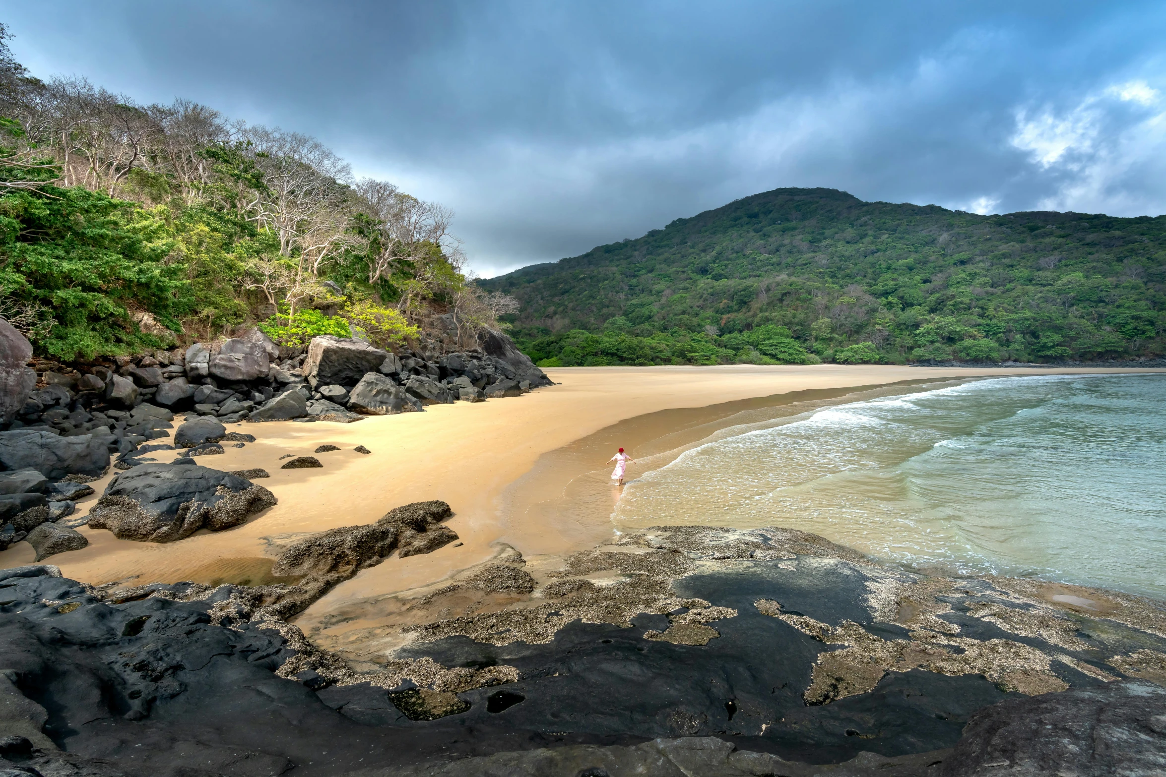 a beach with rocks on it and an ocean view