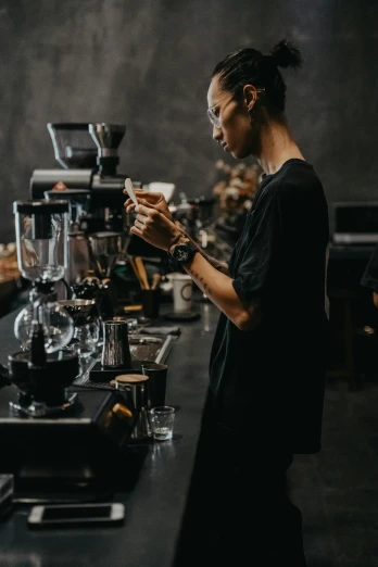 a woman is standing behind a coffee bar